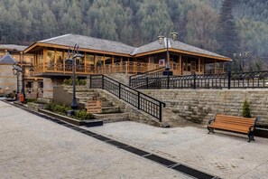 A hotel with a reception area, a balcony, and a stone wall. - Club Mahindra Janjehli Resort (Thunag)