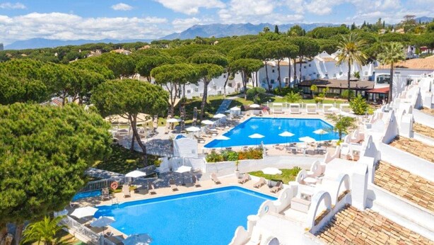 A resort with multiple swimming pools, white buildings, and lush greenery. - Superb townhouse with big sunny terrace (Marbella)