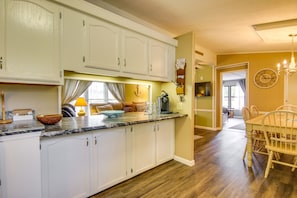 Enjoy meals in this well-appointed kitchen with a dining table, oven, and sink.