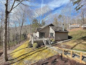 A house with a sloped roof, a front porch, and a small deck. - Cozy wooded mountain retreat 10 minutes from downtown Asheville (Asheville)