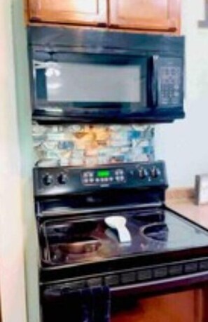 A kitchen with a microwave and stove.
