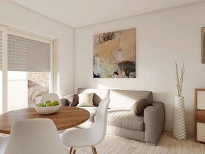 Relax in this stylish living room with a round dining table, comfortable sofa, and a beautiful abstract painting.