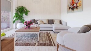 A modern living room with a sofa, a coffee table, and a large plant. - Apartments Villa Subic - Two Bedroom Apartment with Balcony A2 (Kampor)