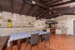 Enjoy al fresco dining in this charming outdoor space with a grill and comfortable seating for four.