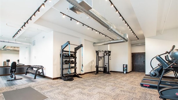 A gym with exercise equipment, a standing desk, and a treadmill. - 107- Brand New Studio near Glacier Park (Columbia Falls)