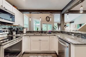 Fridge, microwave, oven, stovetop - Inviting riverfront home with hot tub, firepit, W/D, & dog-friendly (Tahuya)