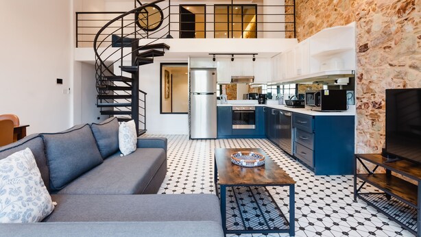 A modern apartment with a living room, kitchen, and a spiral staircase leading to an upper level. - Lefevre 1B (Panama City)
