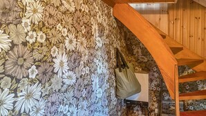 Eine Treppe mit floraler Tapete und einem Holzgeländer.