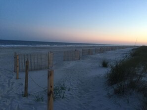 A sandy beach with wooden fences and sparse vegetation. - BEACH Across Street Walk to Restaurants/Beach/Shops- 2 King Beds 1st Floor Villa (Hilton Head Island)