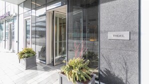 A modern building with large glass windows, a visible entrance, and a sign for 'TRIDEL'. - GLOBALSTAY. Executive 2BR 2BA Condo in DT. Gym, Pool, Hot Tub (Toronto/Canada)
