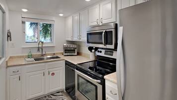 Condo, Multiple Beds, Balcony, Ocean View (#1F) | Private kitchen | Fridge, microwave, oven, stovetop