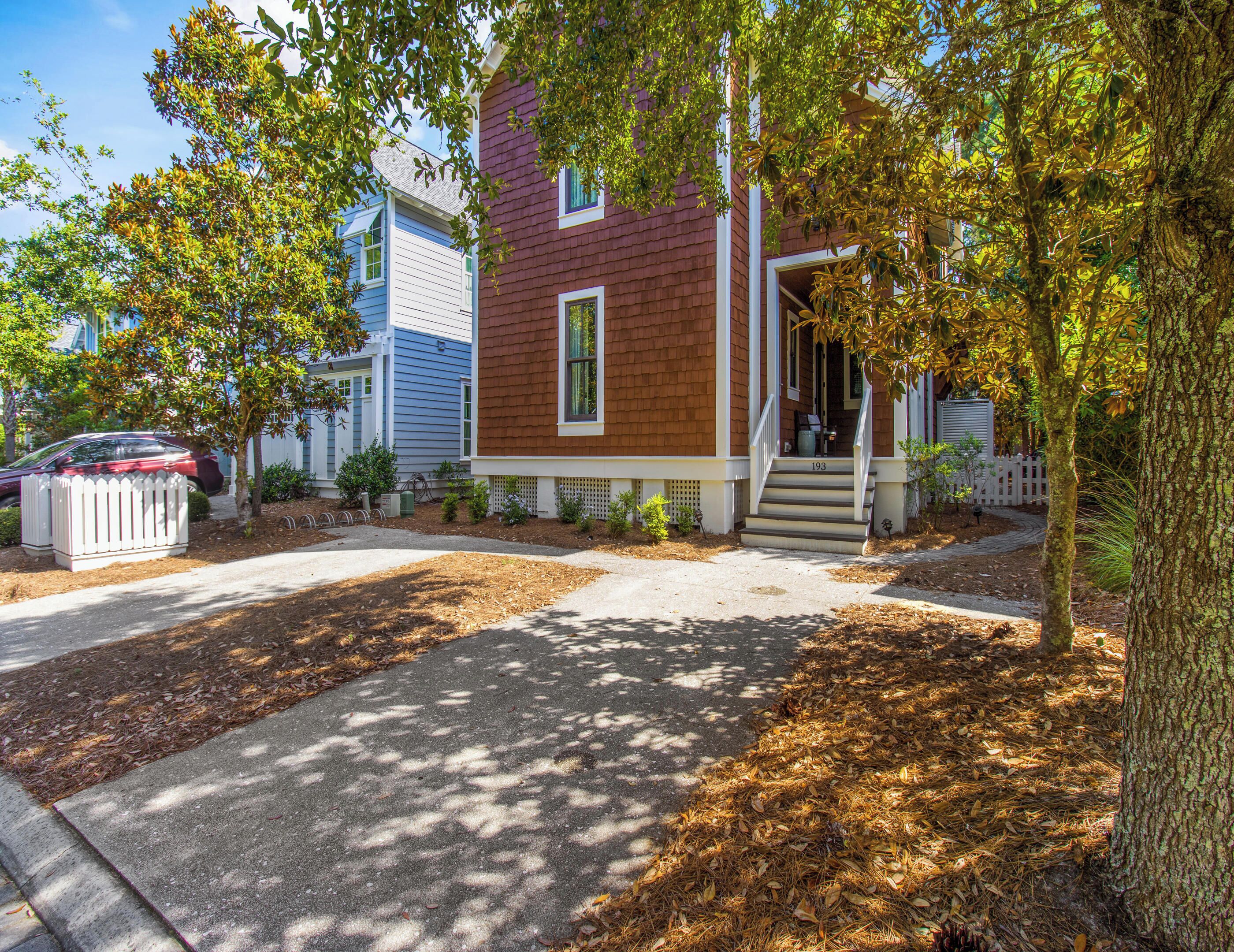 A two-story house with a front porch, a mailbox, and a driveway.