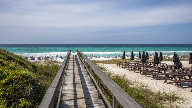 A wooden boardwalk leading to a beach with picnic tables and umbrellas. - Seaspray by Southern Vacation Rentals (Miramar Beach)