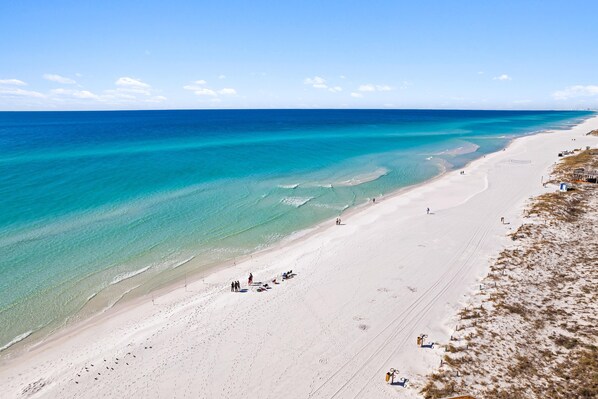 Relax on the wide, pristine beach with ample space for sunbathing and comfort.