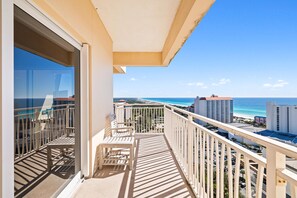 Enjoy breathtaking ocean views from this balcony with a cityscape in the distance.