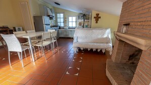 A spacious living area with a dining table, chairs, a sofa, and a fireplace. - ROMANTIC PENTHOUSE 7 BEDS (Case Alte)