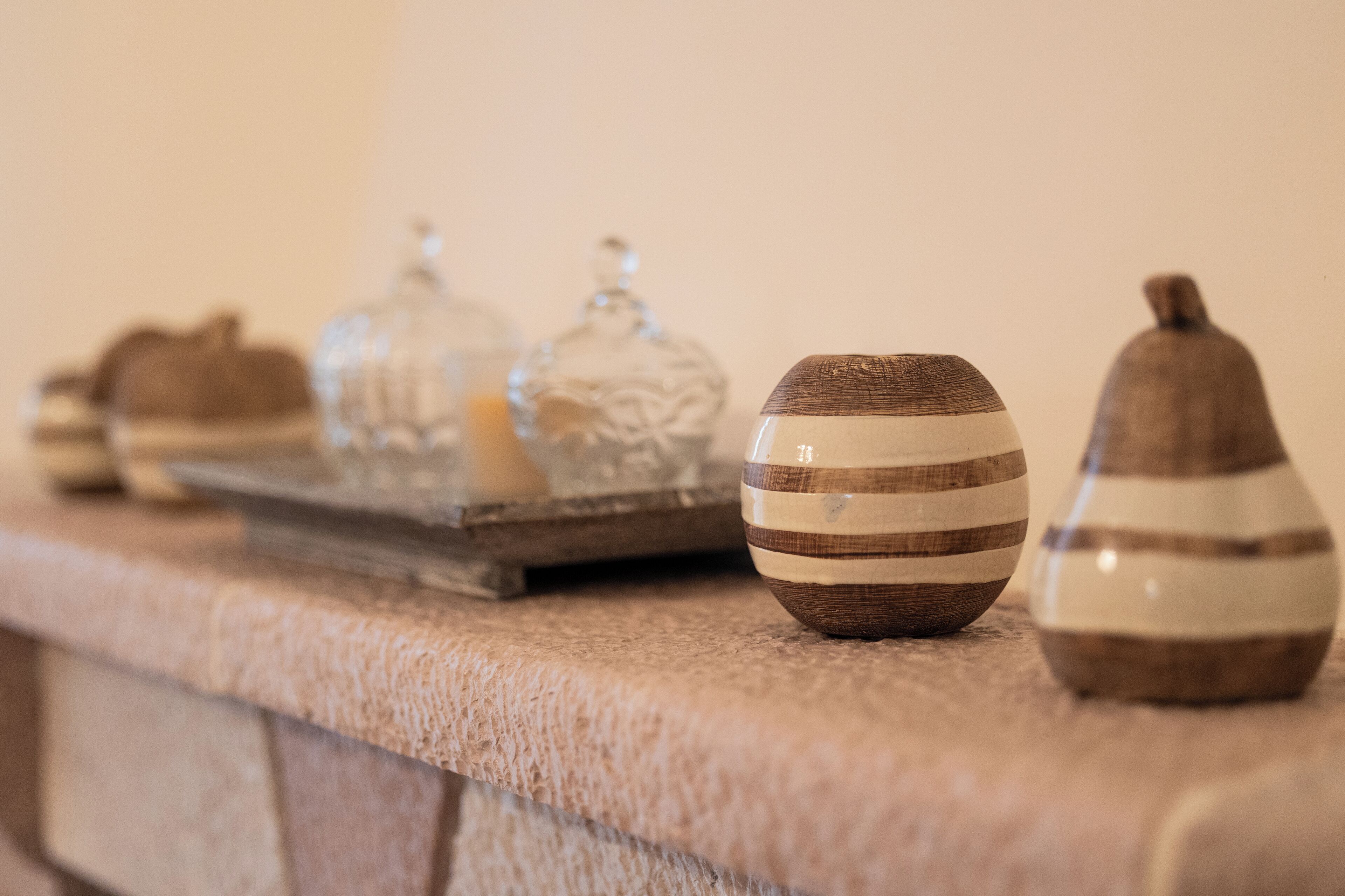 A row of decorative vases on a stone ledge.