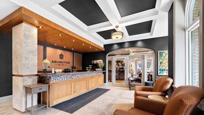 A hotel lobby with a reception desk, seating area, and a view of the interior. - The Arlington Hotel, Bw Signature Collection (Brant)