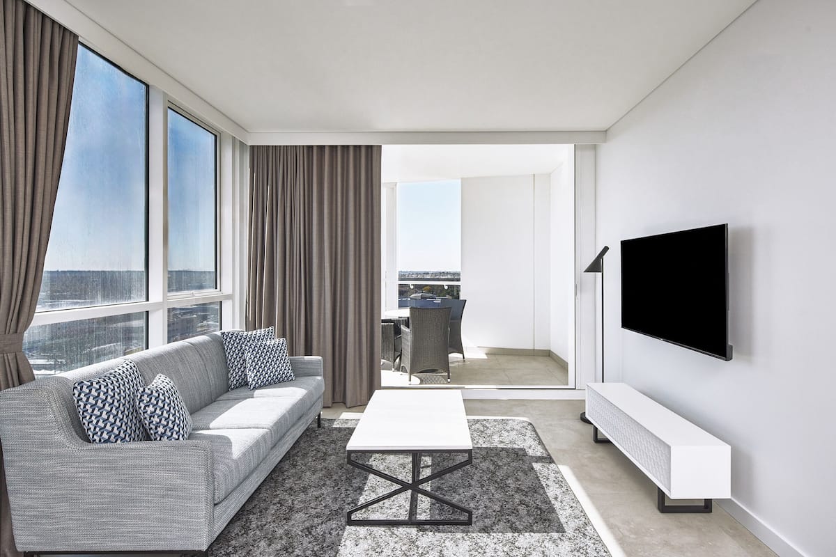 A modern living room with a sofa, coffee table, and TV.