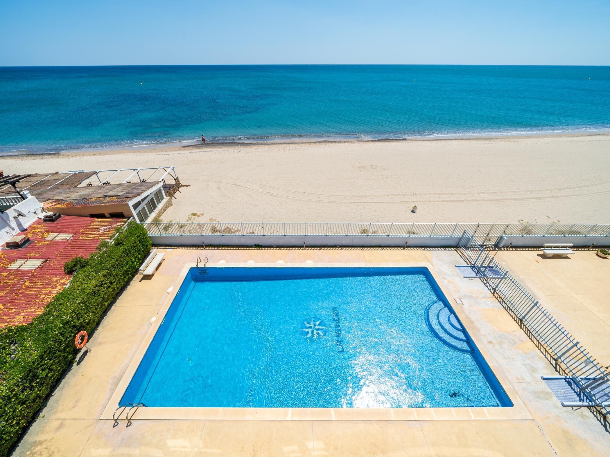 Une piscine sur le toit offrant une vue sur la plage et l’océan.