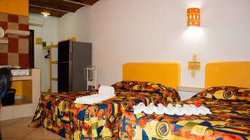 Economy Quadruple Room, Kitchenette | Down comforters, individually decorated, iron/ironing board, free WiFi