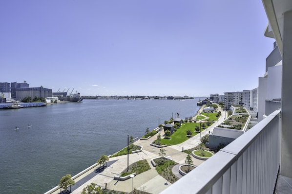 Enjoy breathtaking views of the river and surrounding landscape from this high-rise's expansive balcony.