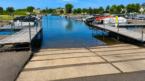 A marina with docks and boats. - Lakeside Retreat at Izatys - Unit #230 – The Perfect Getaway for All Seasons! (Onamia)