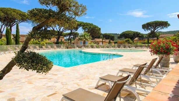 A pool area with lounge chairs, a stone deck, and trees. - House for 4 people with air conditioning in a private domain with a pool located in Gassin (GASSIN)