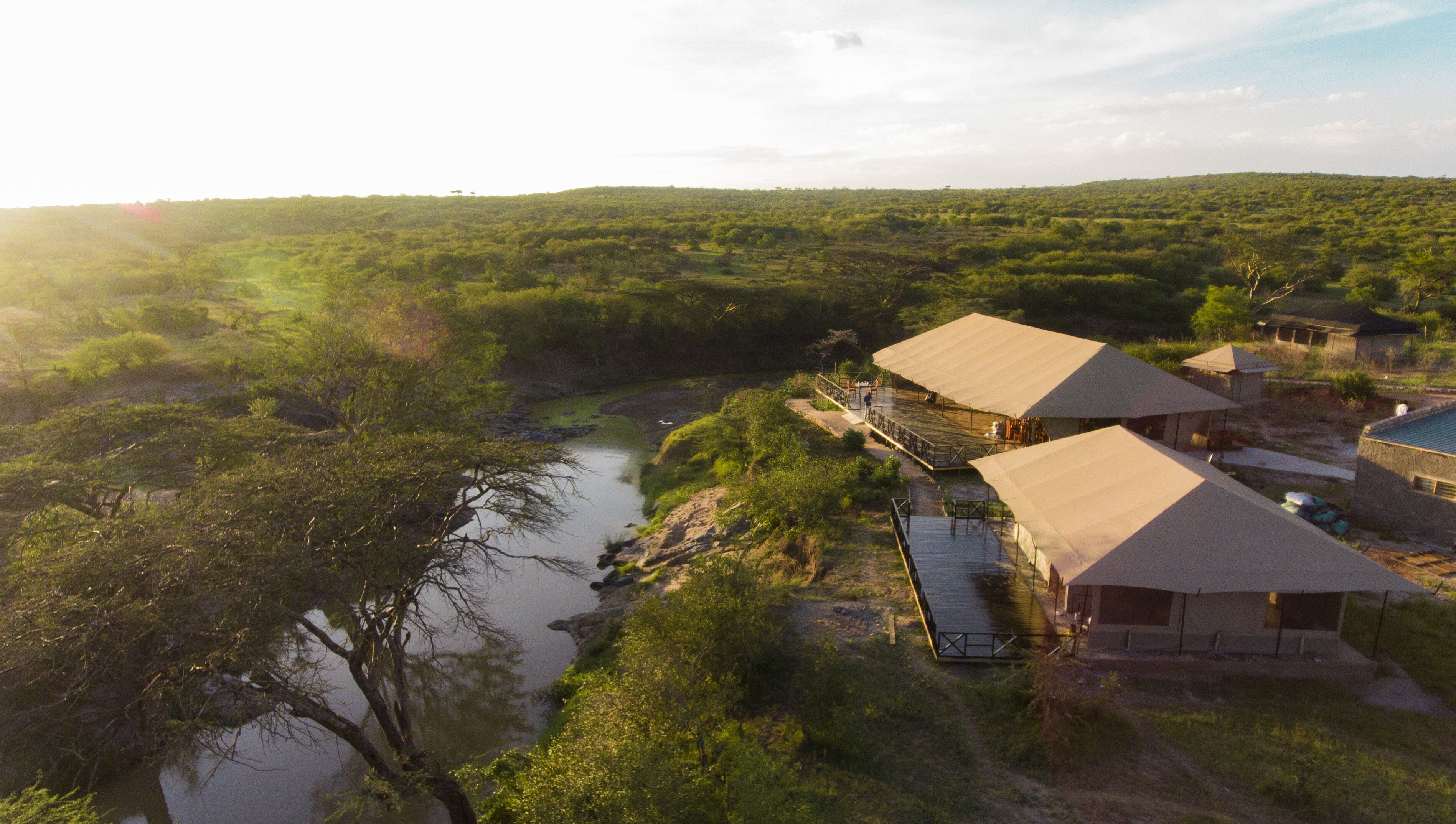 A campsite with tents and a river.