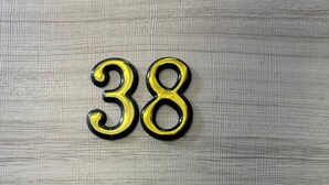The number 38 on a textured surface.