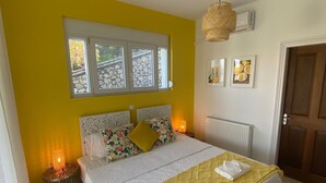 A bedroom with a bed, a window, a radiator, and a door. - Private Villa and Pool With Lake Views and Sunset Terraces at The Grove (Corfu)