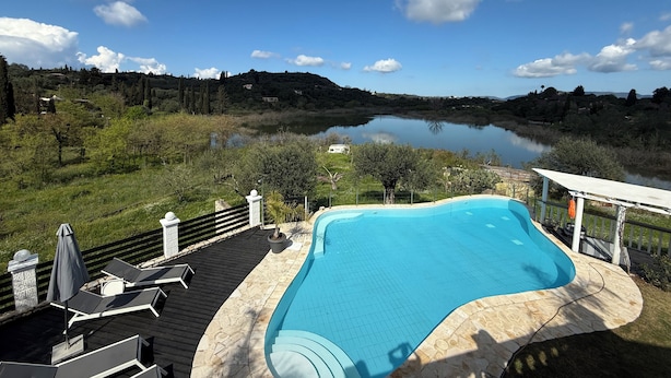 A swimming pool with a view of a lake and hills. - Private Villa and Pool With Lake Views and Sunset Terraces at The Grove (Corfu)