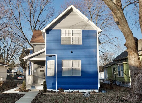 Stunning two-story home with a gabled roof and inviting front porch.