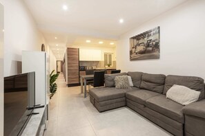 베이직 아파트, 침대(여러 개), 바다 전망 | 거실 공간 | TV