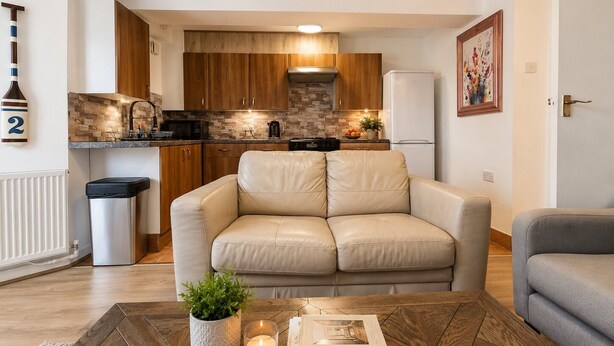 A modern kitchen with wooden cabinets, a built-in microwave, and a refrigerator.