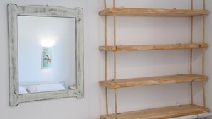 A mirror with a distressed frame, wooden shelves, and a wall-mounted light fixture. - Holiday Home 'Green Retreats 1 Paros' with Mountain View, Wi-Fi and Air Conditioning (Glifades)