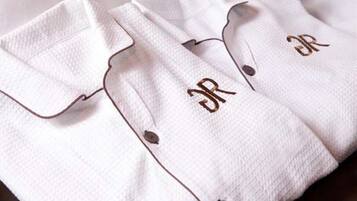 A white shirt with a button and a monogram on the cuff.