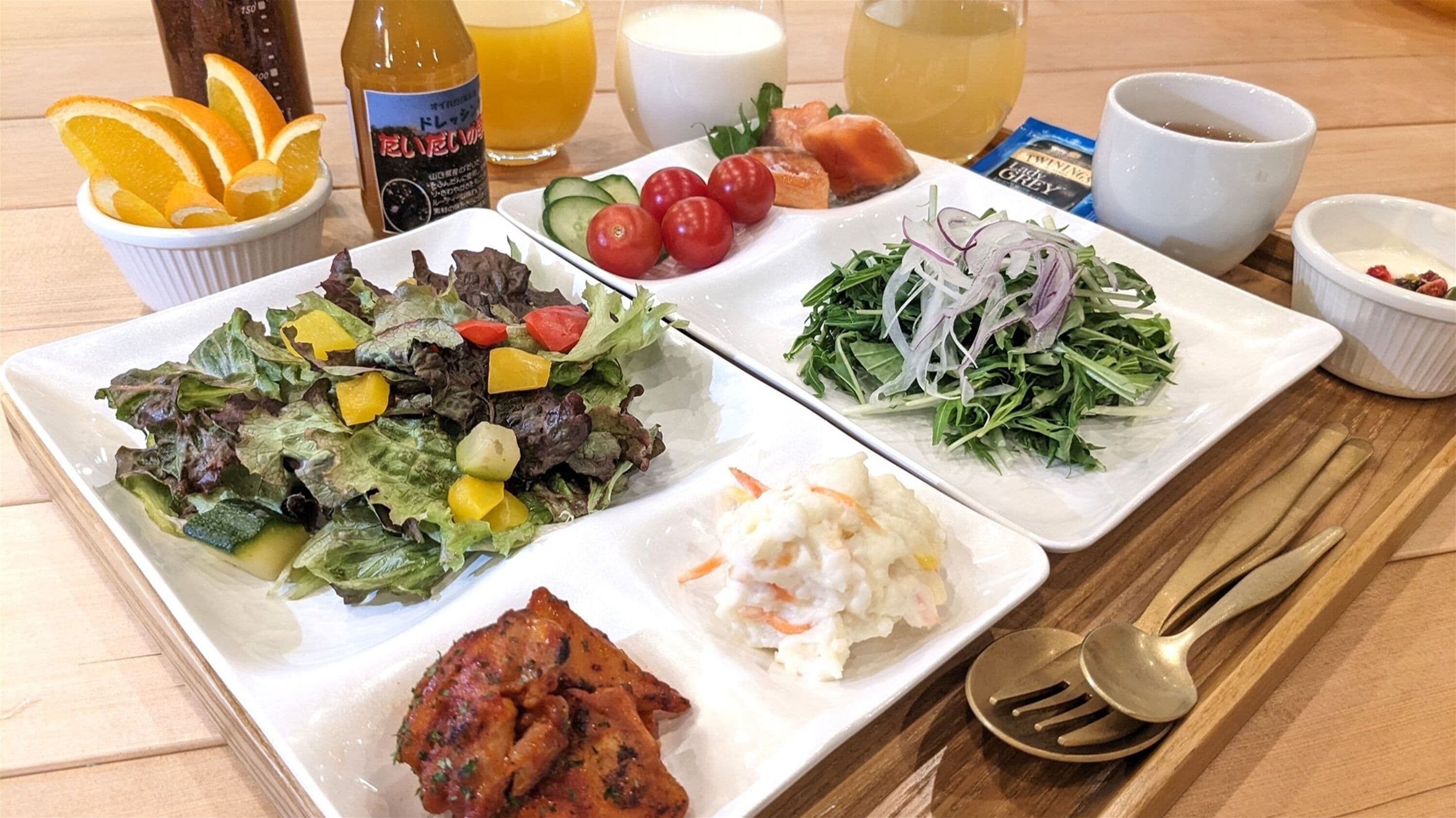 A meal with various dishes including salad, coleslaw, and a side of rice.