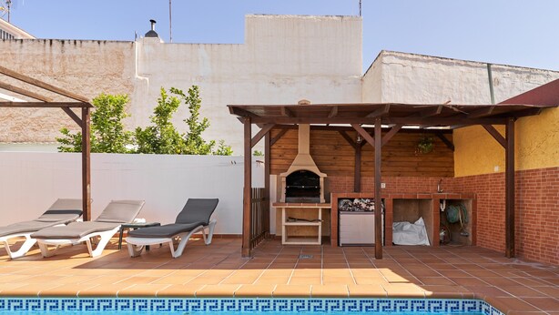 A swimming pool with lounge chairs, a barbecue area, and a covered seating area. - Holiday Apartment "Vivienda Con Piscina" with Private Pool, 3 Terraces & Wi-Fi (Nerja)