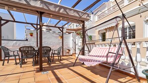 A covered outdoor area with a swing, chairs, and a table. - Holiday Apartment "Vivienda Con Piscina" with Private Pool, 3 Terraces & Wi-Fi (Nerja)