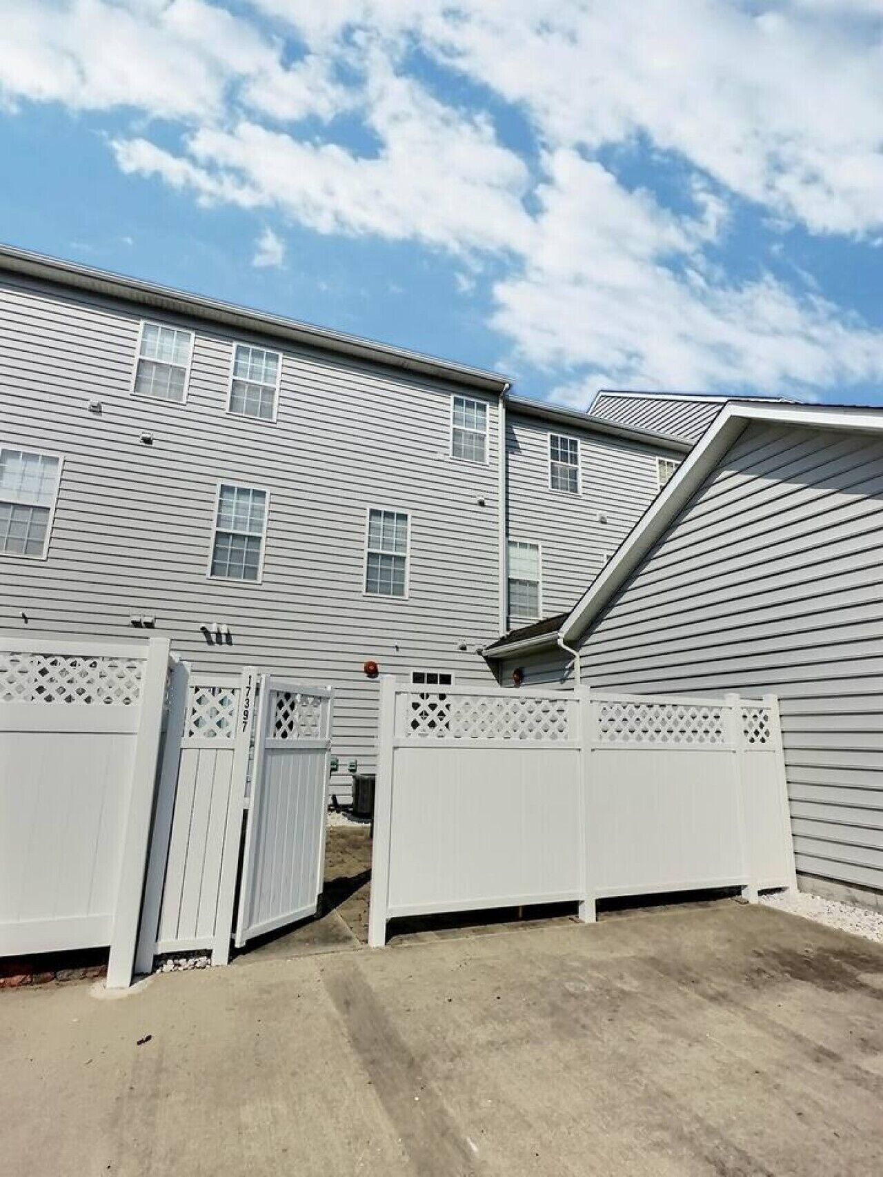 A residential building with a sloped roof and multiple windows.