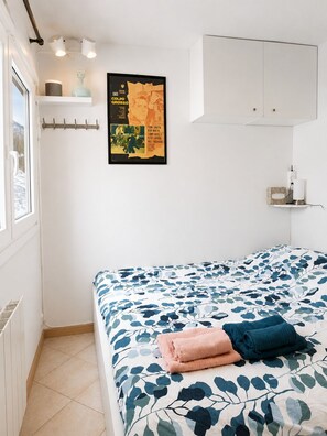 A bedroom with a bed, a poster on the wall, a window, and a white cabinet. - Superbe 3-pièces au Pied des Pistes, Plein sud (Montgenèvre)