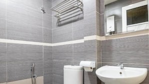 A modern bathroom with a toilet, bidet, and sink, all in white. - Best View SS15 (Subang Jaya)