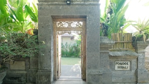 A stone entrance with a sign reading "PONDOK SEBALI".