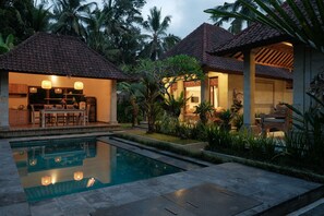 A resort with a swimming pool, outdoor seating, and tropical vegetation. - Pondok Sebali Private Villa (Ubud)