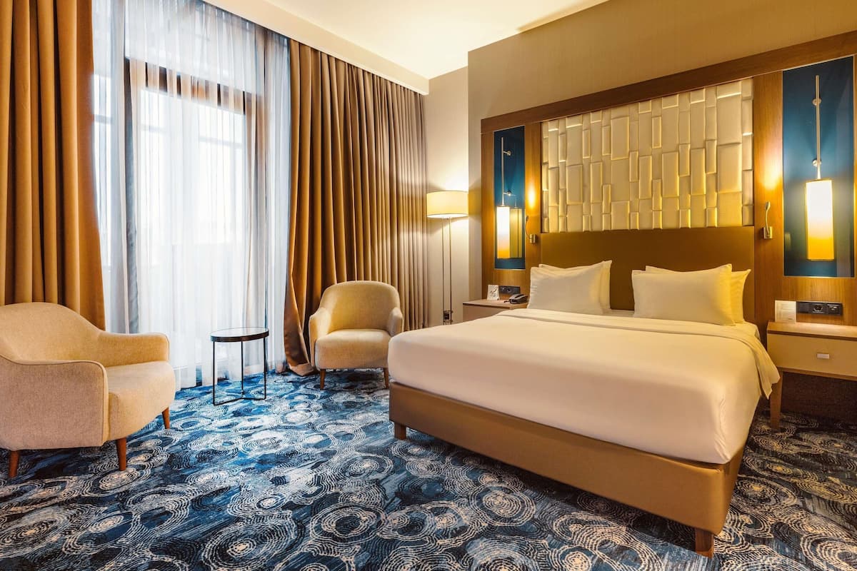 Deluxe Room, 1 Double Bed, Balcony | In-room safe, desk, laptop workspace, blackout curtains