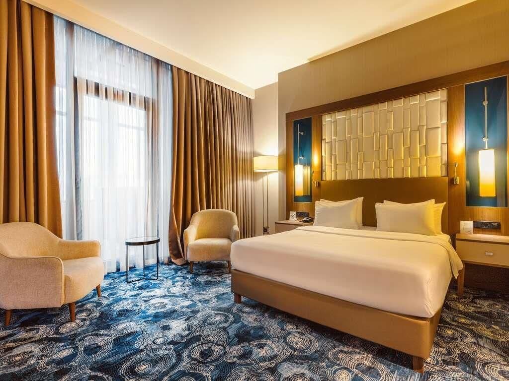 Deluxe Room, 1 Double Bed, Balcony | In-room safe, desk, laptop workspace, blackout curtains