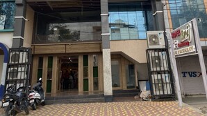 A hotel with a modern facade, large windows, and a sign indicating it offers a bar and restaurant. - Hotel Brij Residency (Bhopal)