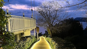 A pathway leading to a building with a view of the water. - The Roof ADA (Adalar)