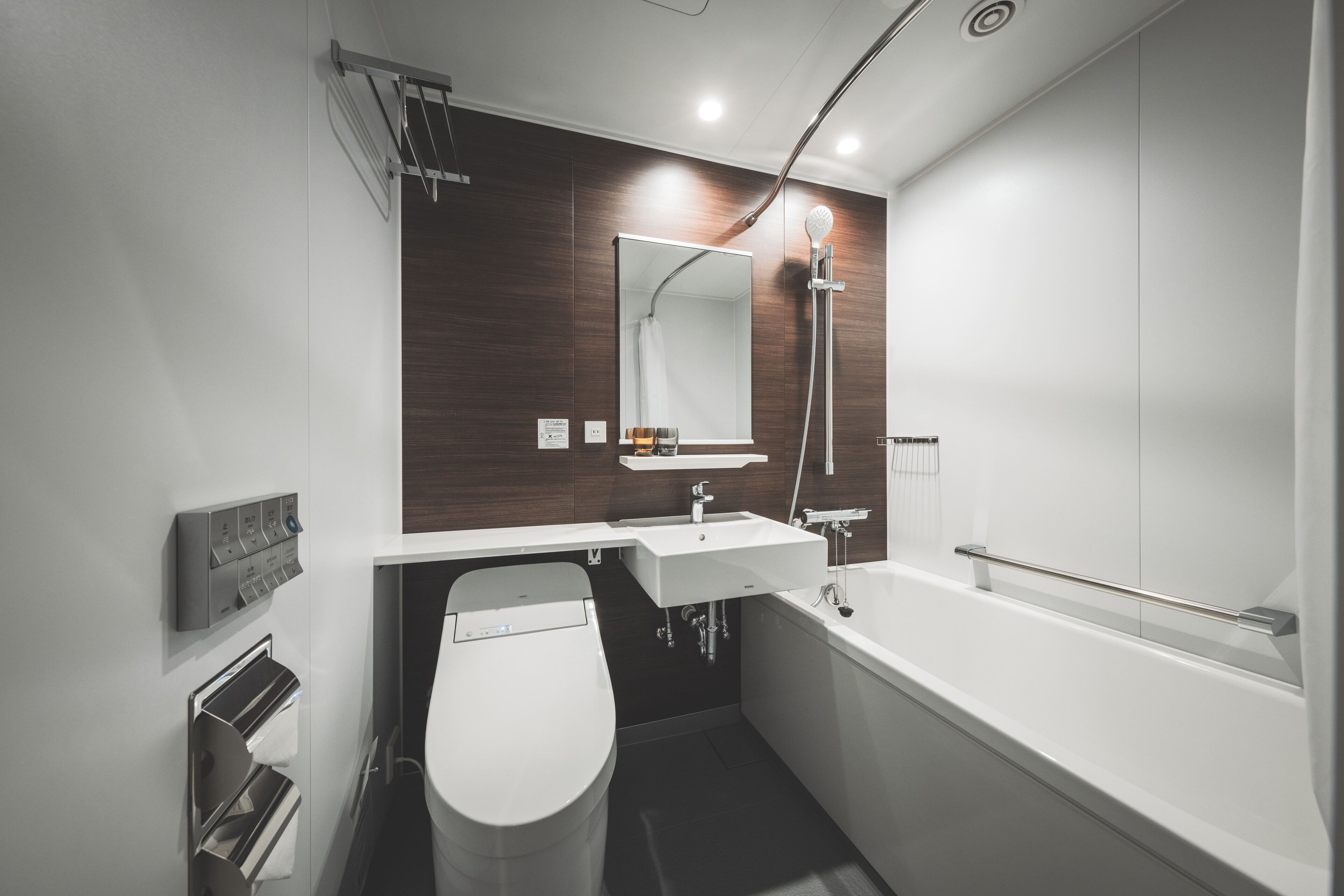 A modern bathroom with a toilet, sink, and bathtub.